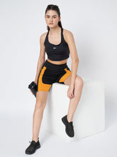 Waylene Black and Mustard Sports Shorts for Men, front view with model sitting