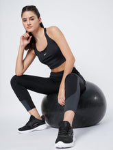 Waylene High-Waisted Black and Grey Yoga Leggings with Model Sitting on Exercise Ball