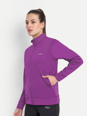 Side view of Waylene's purple 4-way stretch training jacket, worn by a model posing with one hand on her hip, emphasizing the jacket's form-fitting silhouette and side pockets.