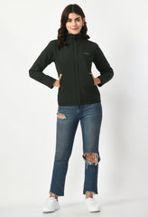 Model wearing Waylene's olive green waterproof winter jacket for women, full-length shot standing with hands in pockets, paired with ripped jeans and white sneakers.