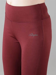 Close-up of Waylene Wine Capri Tights waistband and logo