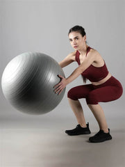 Waylene wine color tracksuit with capri tights, squat pose with exercise ball