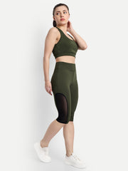 Side view of a model in Waylene's olive green capri tights and sports bra, emphasizing the stylish mesh panels and snug waistband.