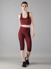 Front view of a model standing in Waylene's wine-colored sports bra and Capri tights, perfect for yoga, gym, and running.