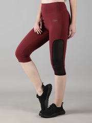 Side view of a model showcasing Waylene's wine Capri tights with mesh panel detailing, ideal for athletic activities.