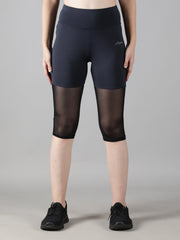 Close-up front view of Waylene's navy blue capri tights, emphasizing the sheer mesh panels and high waistband, ideal for yoga and gym workouts.