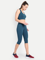 Side view of a model in Waylene's teal blue capri and sports bra set, emphasizing the sleek design and body-hugging fit, ideal for active movements.
