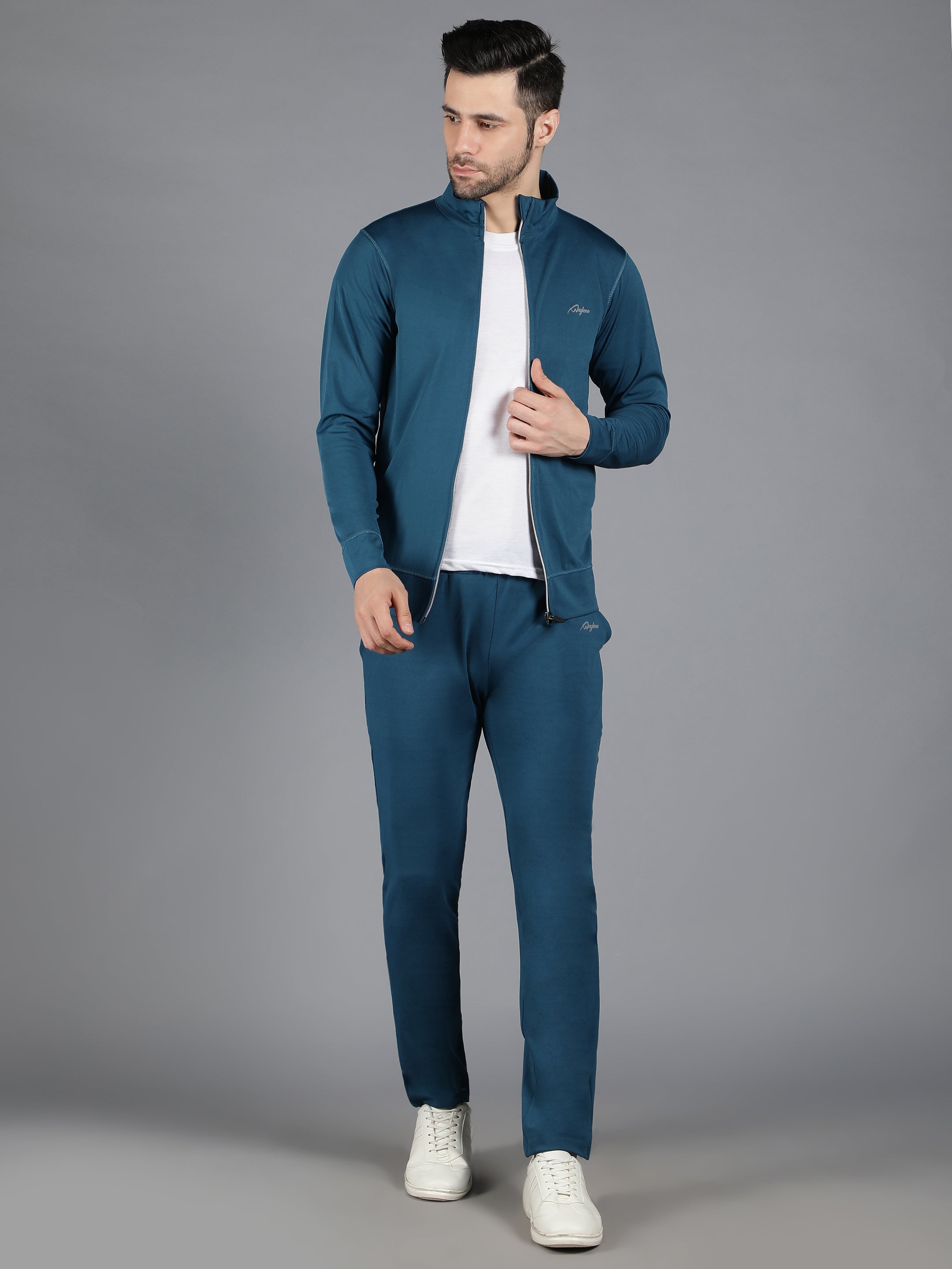 Waylene's slimfit training sweatshirt and trackpant set in teal, model standing with hands in pockets, wearing white sneakers