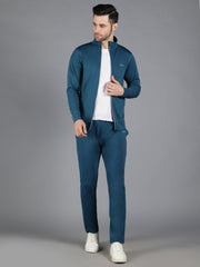 Waylene's slimfit training sweatshirt and trackpant set in teal, model standing with hands in pockets, wearing white sneakers