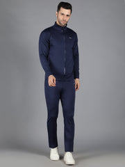 A side view of Waylene's navy blue slimfit training set, with the model standing straight and hands by his sides, showcasing the sleek silhouette and full zip-up feature of the jacket.
