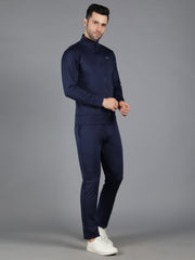 Model in Waylene's navy blue slimfit training sweatshirt and trackpant set, zipped up to the top. The pose is direct and confident, showcasing the streamlined fit of the sweatshirt.
