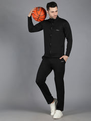 Male model in Waylene's slimfit black training sweatshirt and trackpants, standing with hands in pockets, displaying a casual and relaxed fit. The outfit's streamlined silhouette and subtle branding are highlighted.