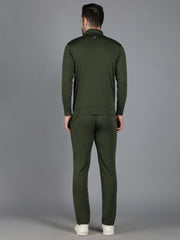 Rear view of Waylene's olive green training sweatshirt and track pant set, modeled by a male standing straight with his back to the camera, highlighting the seamless stitching and fit, against a grey setting.