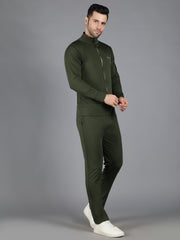 Waylene's olive green slimfit training outfit on a male model unzipping the jacket halfway, posed slightly to the side, against a grey background to emphasize the sporty design.
