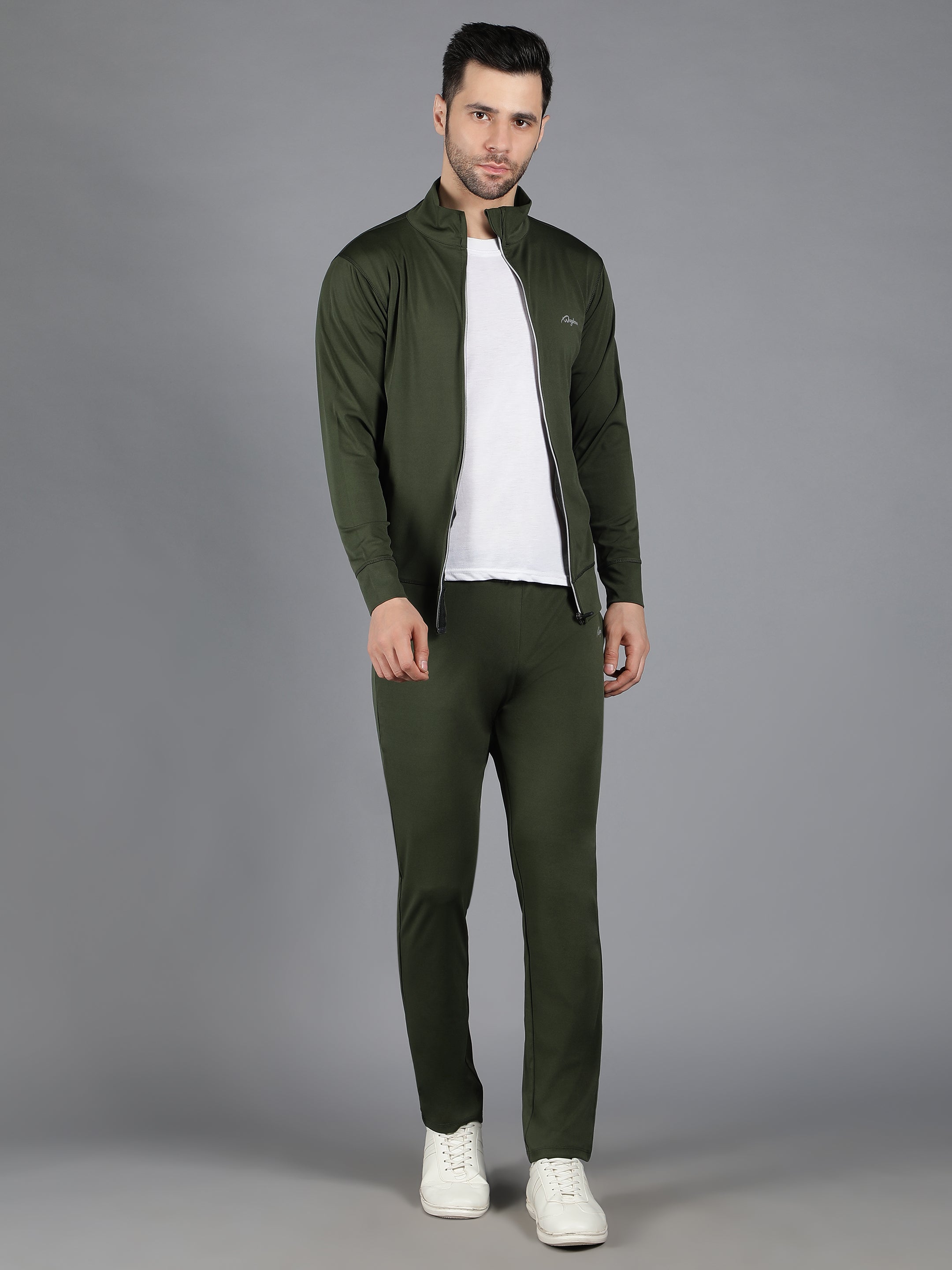Waylene's male model in olive green slimfit training sweatshirt and track pant set, standing with hands in pockets, facing forward in a neutral pose on a grey background.