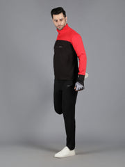 Waylene's red and black slimfit training tracksuit for men, model standing with one hand adjusting the jacket's collar and the other slightly raised, wearing a red and black zip-up jacket and black pants.