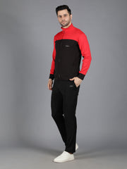 Waylene's red and black slimfit training tracksuit for men, model standing in a confident pose with hands in pockets, showcasing the red and black zip-up jacket and black pants.