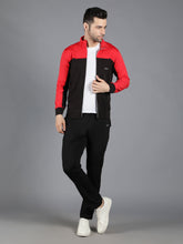 Waylene's red and black slimfit training tracksuit for men, featuring a model in a relaxed pose with a hand in pocket, wearing a red and black zip-up jacket and black pants, paired with white sneakers.