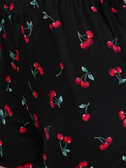 Close-up of Waylene cherry print on black shorts, elastic waistband detail.