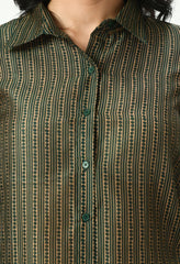 Close-up of Waylene sheer green shirt showing button and stripe details.
