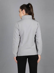 Rear view of Waylene's women's grey waterproof jacket showing the smooth, seamless design and fit, modeled with a casual stance.