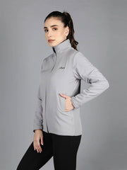 Three-quarter view of a model in Waylene's women's grey waterproof jacket, hand on hip, showcasing the slim fit and high collar.