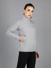 Side view of Waylene's women's grey waterproof jacket with the model placing her hand in the pocket, highlighting the jacket's practical design.