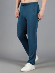 Male model posing with one leg slightly forward, showcasing Waylene's teal blue solid trackpant with adjustable drawstring.