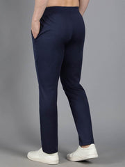 Rear view of Waylene's navy blue solid trackpant on a male model, emphasizing the elastic waistband and streamlined fit