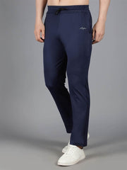 Waylene's navy blue solid trackpant worn by a male model, showcasing a slight forward step with hands partially in pockets