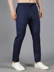 Man modeling Waylene's navy blue solid trackpant in a side view, showing the slim fit and side seam, paired with white casual shoes