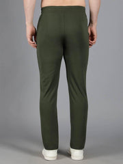 Back view of Waylene's olive green solid trackpant modeled to show the smooth rear fit and elastic waistband, worn with white sneakers.