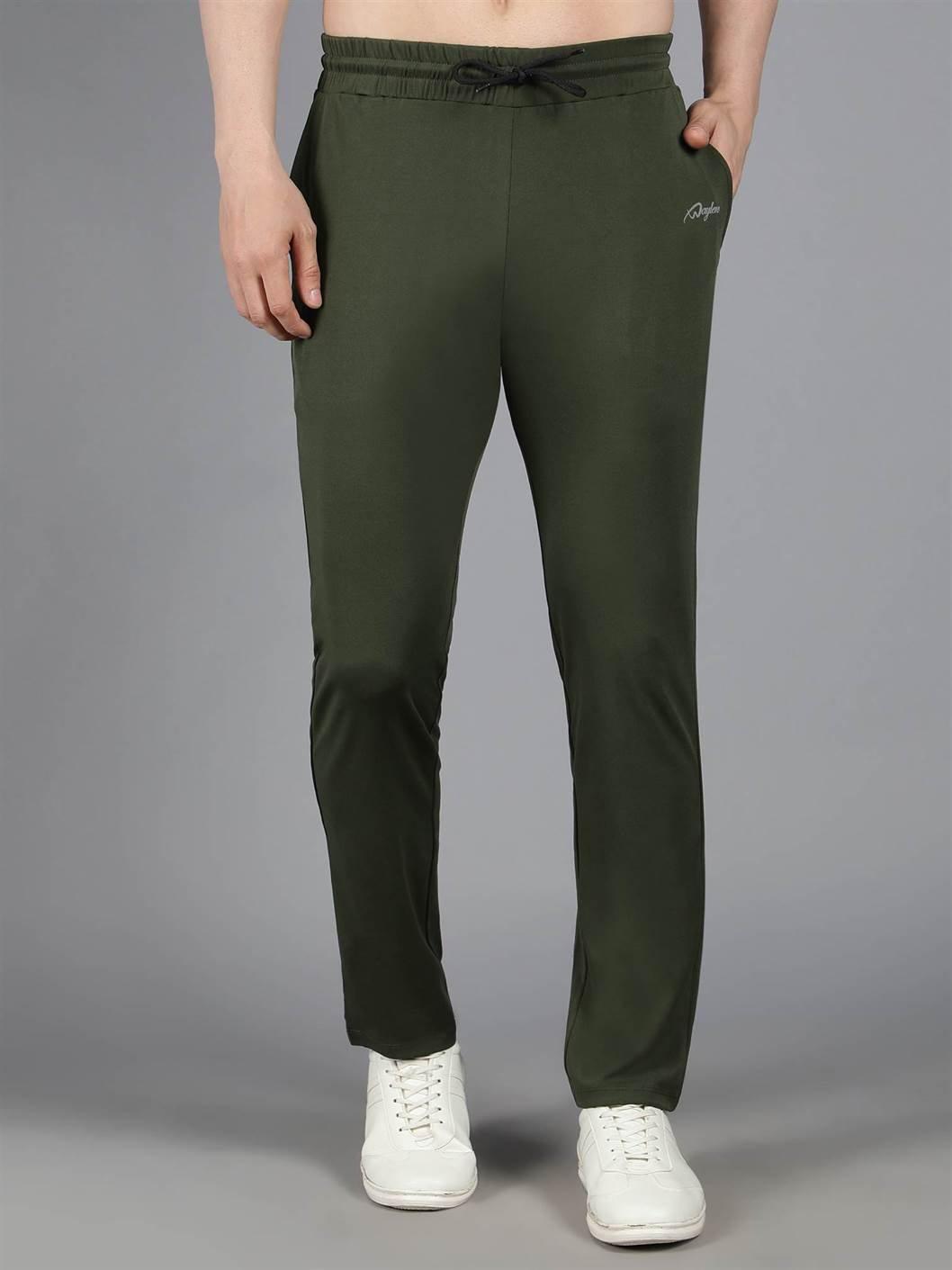 Waylene's olive green solid trackpant featuring a relaxed fit and a drawstring waist, modeled in a straight standing position with hands at sides, paired with white sneakers.