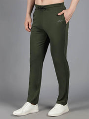 Waylene's olive green solid trackpant showcased by a model casually placing a hand in the pocket, emphasizing the sleek fit and comfortable waistband, paired with white sneakers.