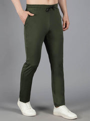 Model displaying Waylene's olive green solid trackpant with a side view, highlighting the streamlined fit and side stitching details, complemented by white sneakers.