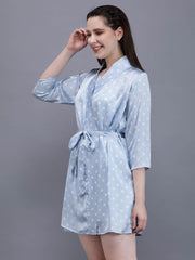 Model smiling and adjusting her Waylene light blue polka dot robe, highlighting the three-quarter sleeves and comfortable wrap design.
