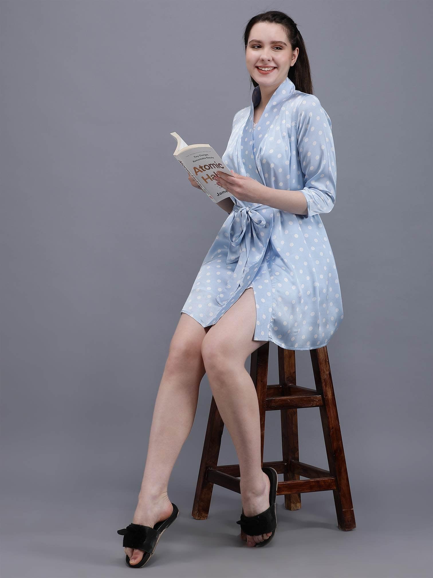 Waylene's light blue polka dot robe, featuring a young woman sitting on a wooden stool, holding a book, wearing a matching cami under the robe, styled with black slippers.