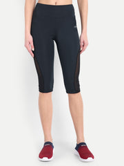 Woman posing in Waylene navy blue high-waisted sports capris with mesh panels front view