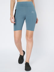 Female model showcasing Waylene's teal mid-thigh sports shorts with a smooth, wide waistband, designed for comfort during physical activities.