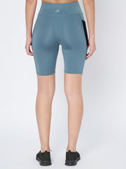 Back view of Waylene's teal sports shorts on a model, highlighting the streamlined design and mid-thigh cut, perfect for running or gym sessions.