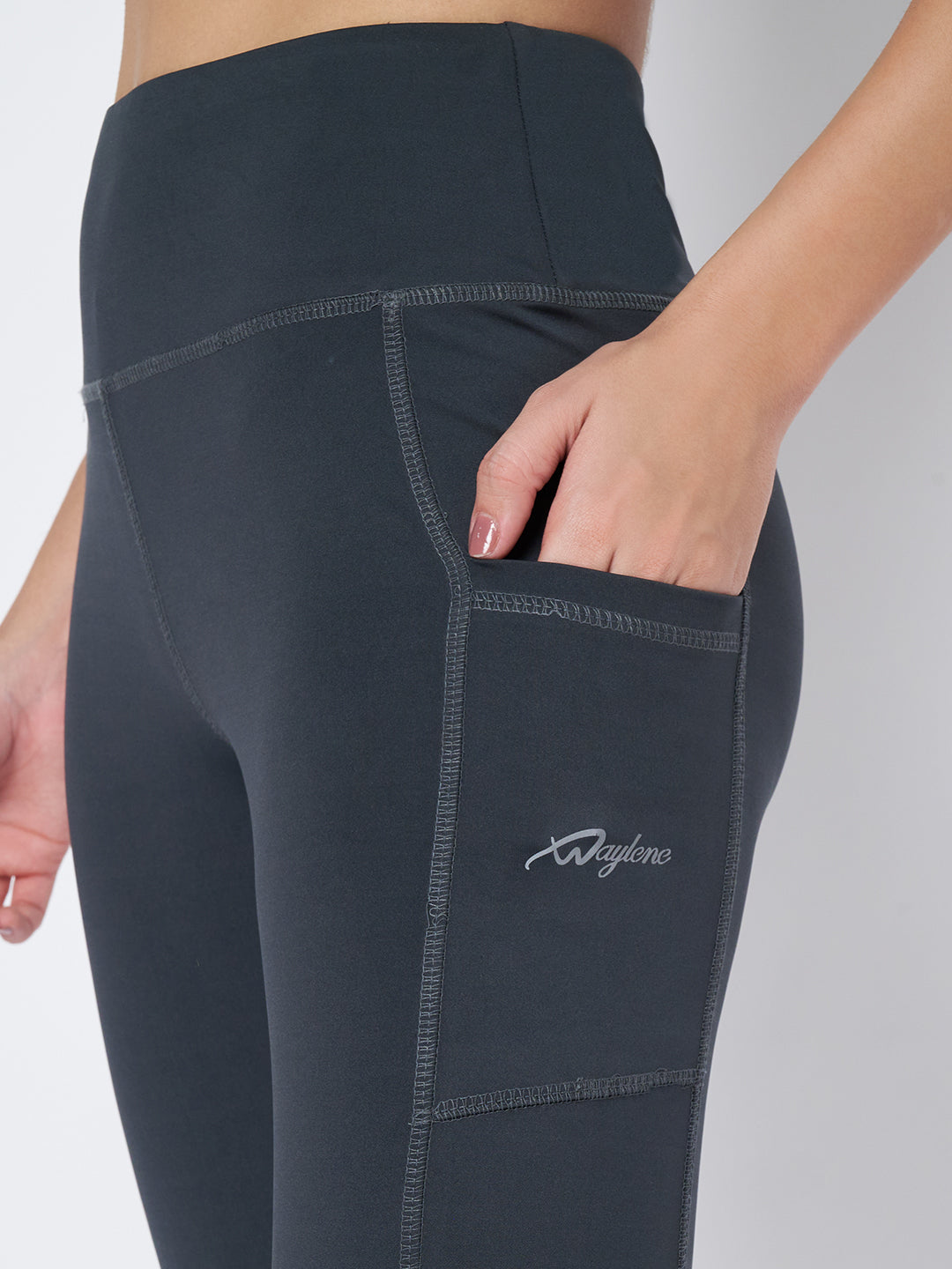 Close-up of Waylene Dark Grey Leggings featuring side pocket and logo detail.