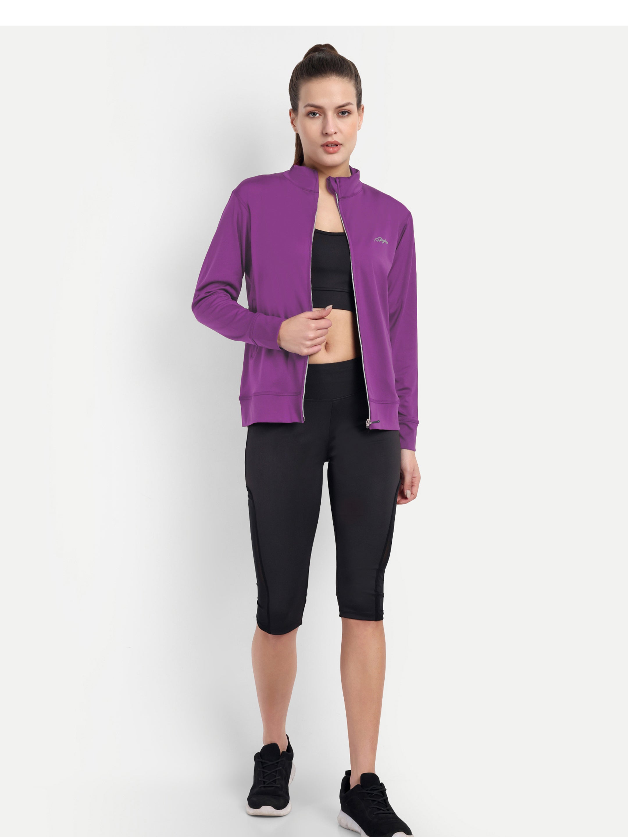 Model wearing Waylene's purple training jacket unzipped halfway, paired with black athletic leggings and sneakers, demonstrating the jacket's versatility and fit.