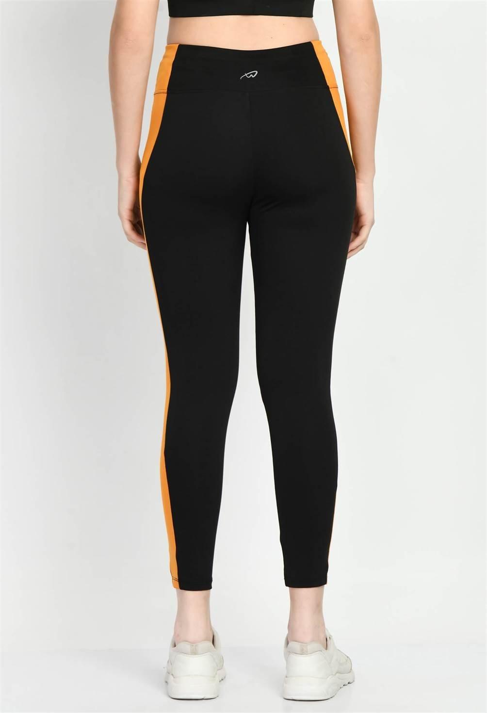 Back view of Waylene Color Block Black and Mustard Tights, displaying high waist and paneled design
