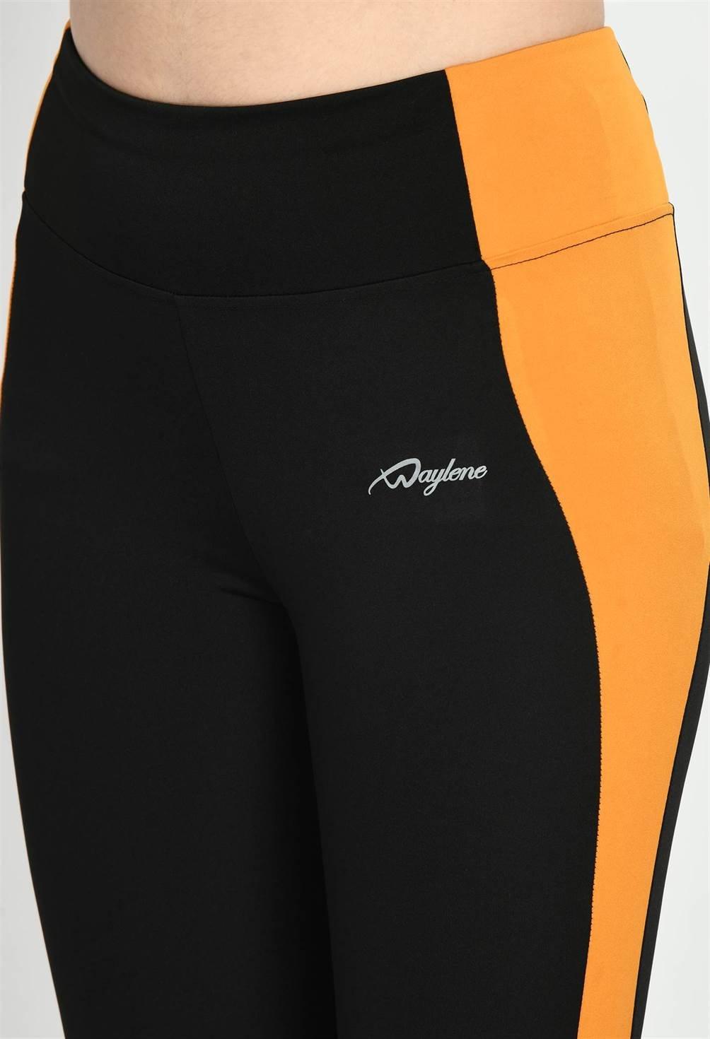 Close-up of Waylene Black and Mustard Tights, highlighting color block design and logo detail
