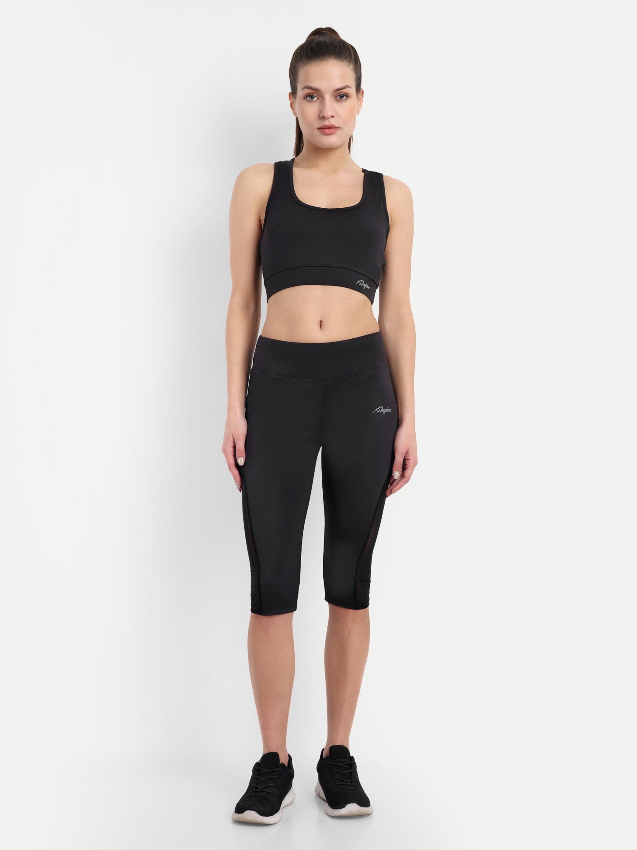 Waylene Women's Black High-Waisted Sports Capris with Mesh Panels, full body view with matching sports bra.