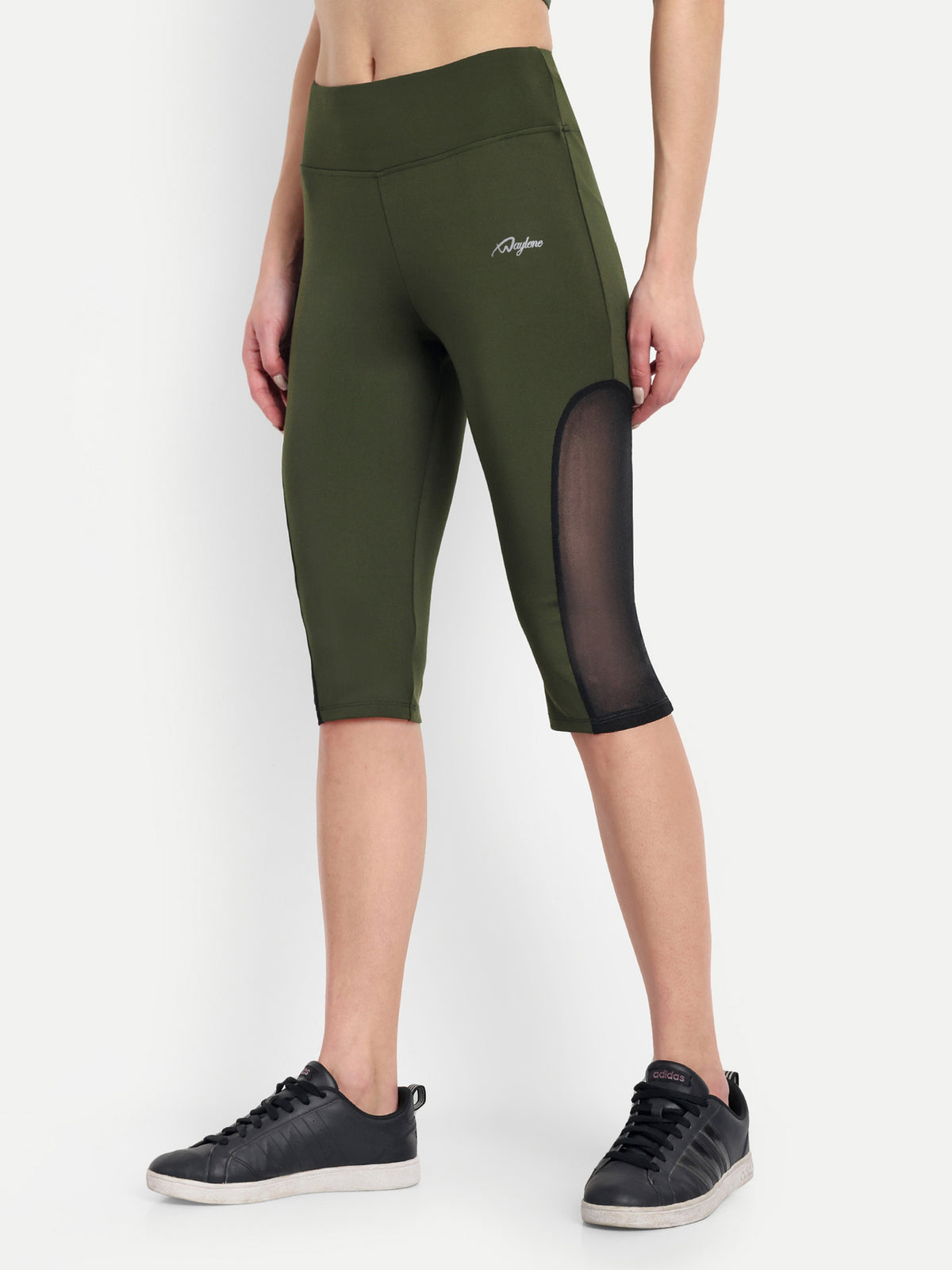 Woman in Waylene olive green high-waisted sports capris with mesh panels side view