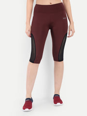 Woman in Waylene maroon (wine) high-waisted sports capris with mesh panels front view