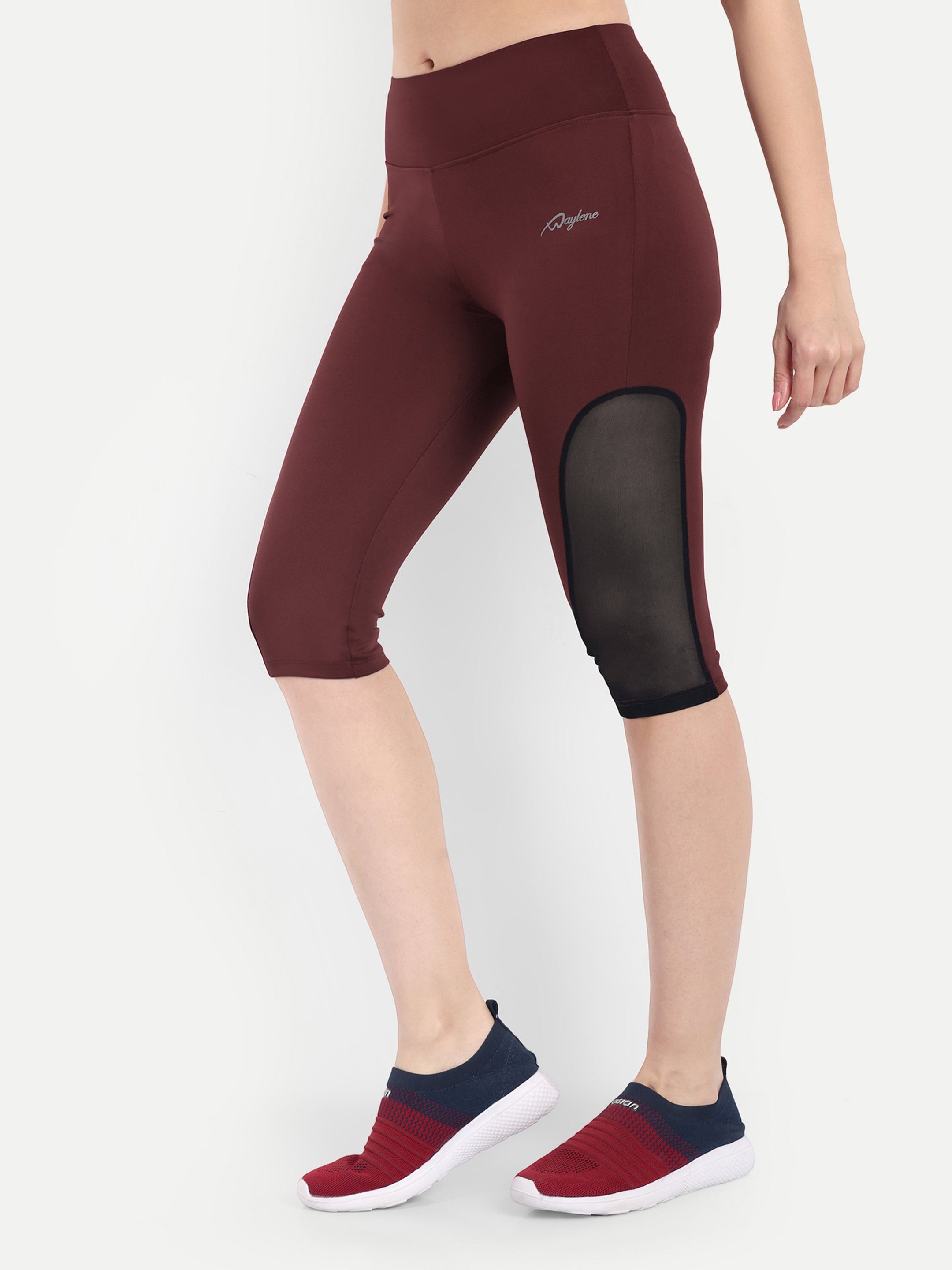 Woman in Waylene maroon (wine) high-waisted sports capris with mesh panels side view