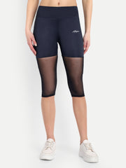 Woman wearing  Waylene navy blue high-waisted capri leggings with rounded mesh panels – front view