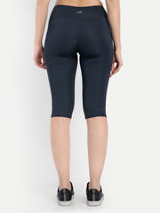 Woman wearing Waylene navy blue high-waisted plain sports capris back view